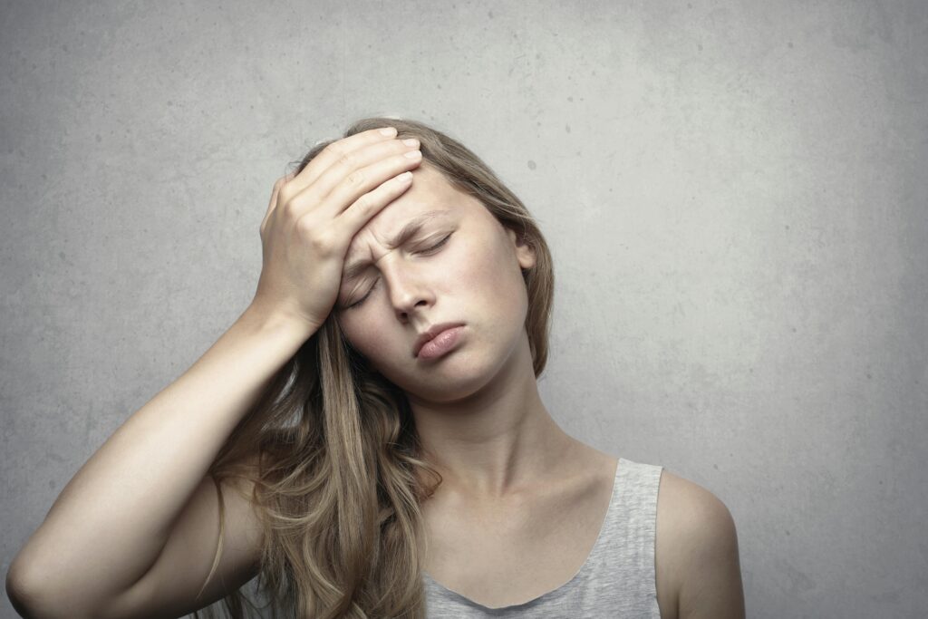 pexels photo 3812757 3812757 A woman in distress holding her head, expressing emotion and fatigue.